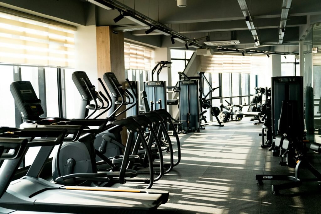 A row of exercise machines in a gym